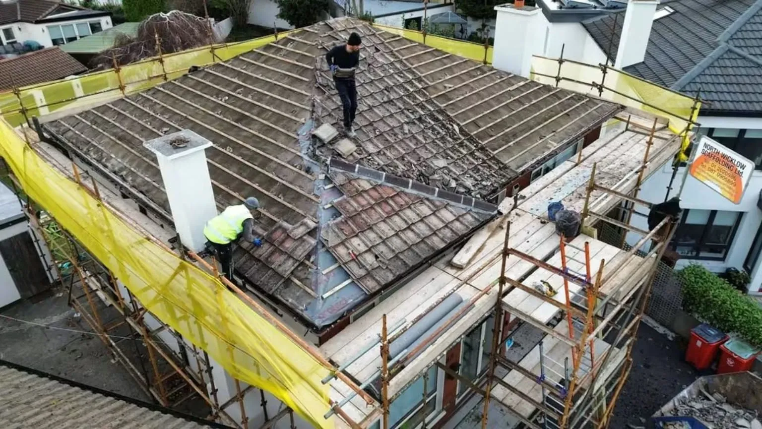 Stripping the old roof tiles under scaffolding in Rathfarnham